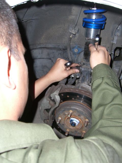 1996 Ford Probe - Close-up of a car's suspension system, focusing on the coilover and brake components.