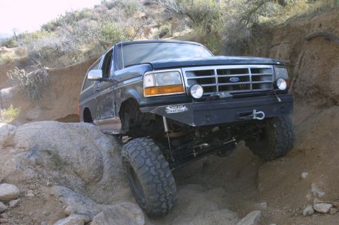 1994 Ford Bronco - This 1994 Ford Bronco is navigating a challenging off-road course with steep inclines and large boulders.
