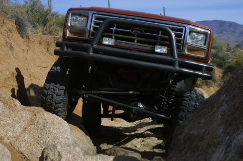 1994 Ford Bronco - This Ford Bronco is tackling a tough, rocky terrain with its front end angled towards the camera.