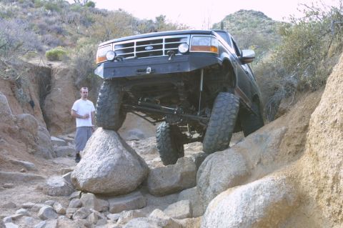 1994 Ford Bronco - This 1994 Ford Bronco is tackling a challenging off-road course with large rocks.