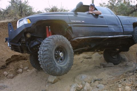 1994 Ford Bronco - Customized Dodge Ram 2500 navigates challenging off-road obstacles.