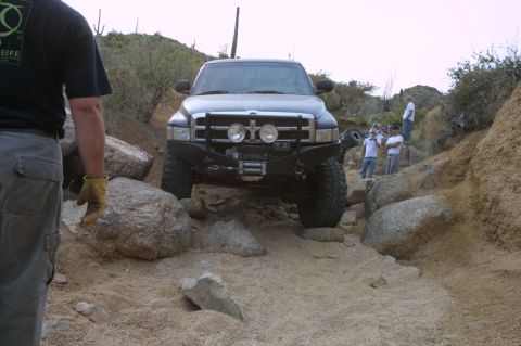 1994 Ford Bronco - A truck is shown off-roading on a challenging rocky terrain.