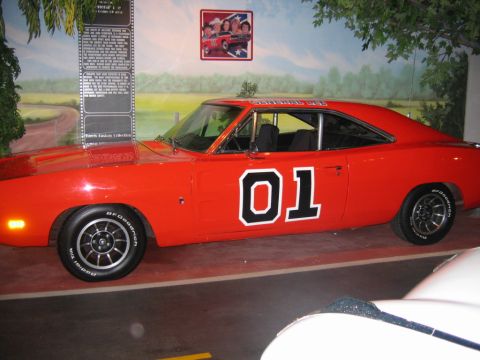 1985 Ford Crown Victoria LTD - The iconic General Lee from The Dukes of Hazzard is displayed indoors.