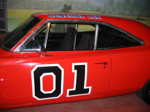 1985 Ford Crown Victoria LTD - The iconic General Lee from The Dukes of Hazzard is seen here in a side profile, displaying its signature "01" and name on the roof.