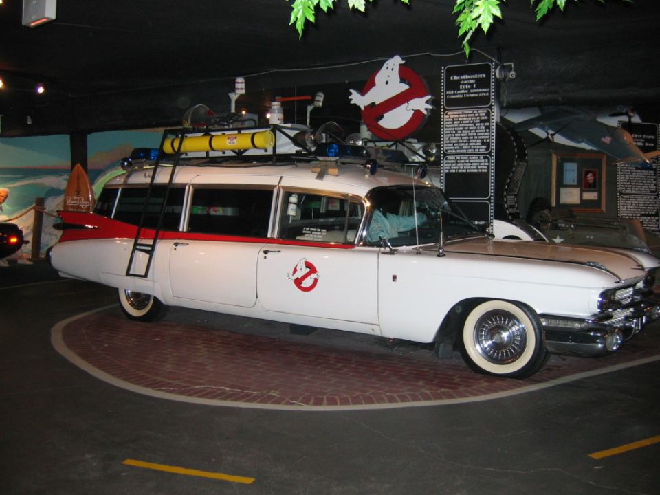 White 1959 Cadillac Miller-Meteor ambulance with red trim, Ghostbusters logo, and roof rack