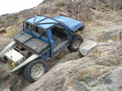 1989 Ford Bronco - This modified off-road vehicle navigates a challenging rocky path.