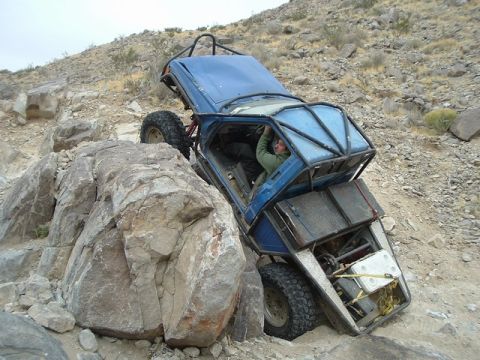 1989 Ford Bronco - Off-road buggy with custom roll cage attempts to climb a steep, rocky terrain.