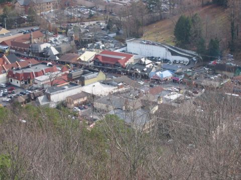 1985 Ford LTD Crown Victoria - A wide shot shows a town with numerous buildings and vehicles, taken from a high vantage point.