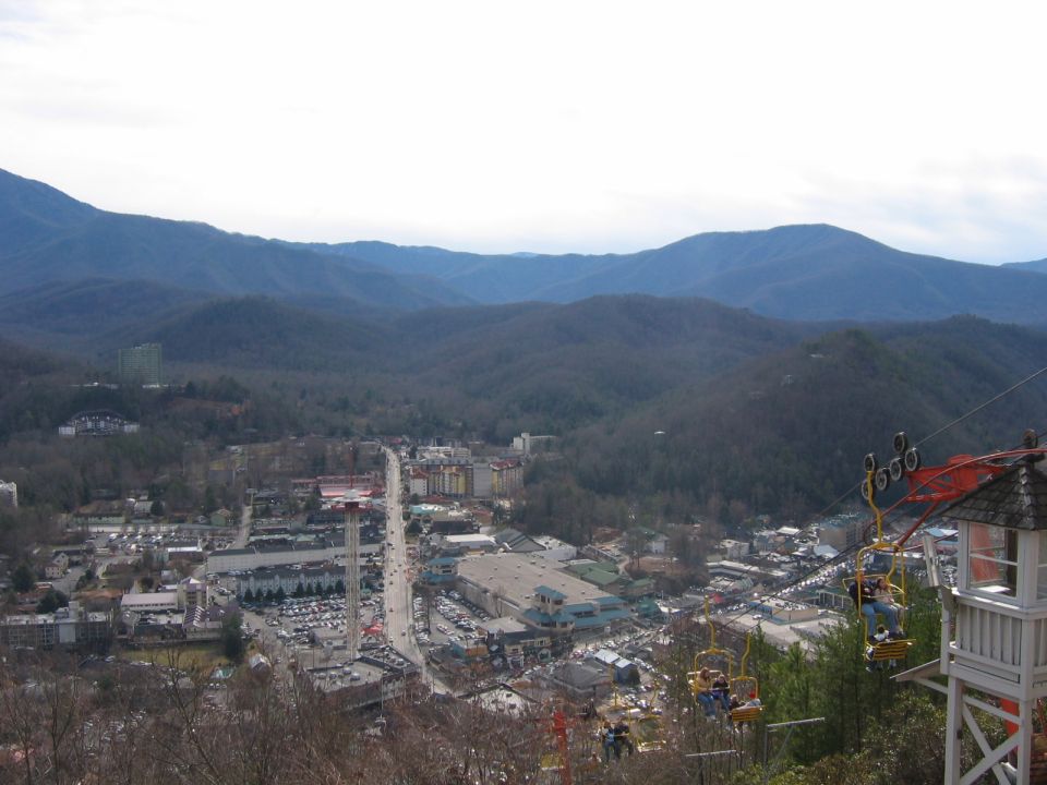View of a mountain town with a ski lift in the foreground