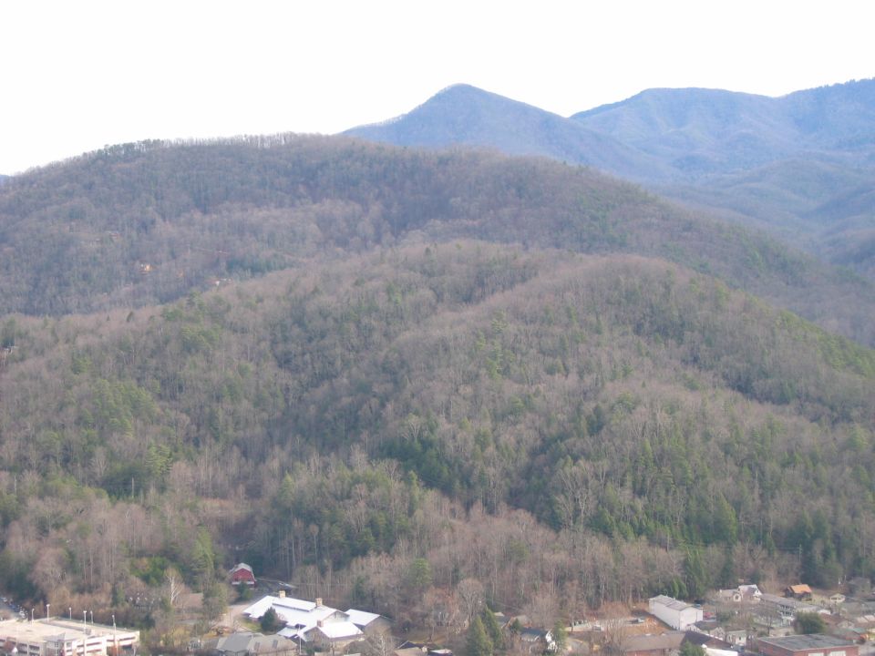 View of mountains and a small town with buildings and trees