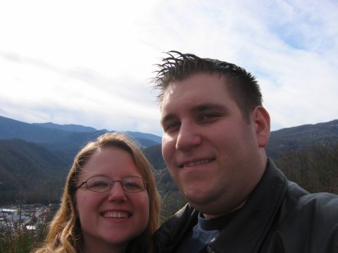 1985 Ford LTD Crown Victoria - A couple poses for a photo with a scenic mountain view behind them.