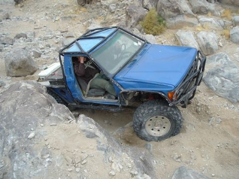 1989 Ford Bronco - Modified 1989 Ford Bronco tackling a challenging rocky trail during an off-road excursion.