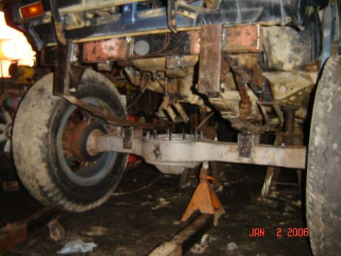 1982 Nissan Titan - Close-up of a vehicle's rear axle and suspension system, with a date stamp from 2006.