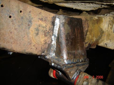 1982 Nissan Titan - A close-up view of a welded reinforcement on a rusty truck frame shows recent modifications.