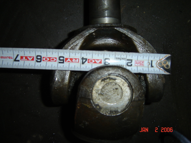 Close-up of a universal joint with a tape measure showing approximately 3.5 inches