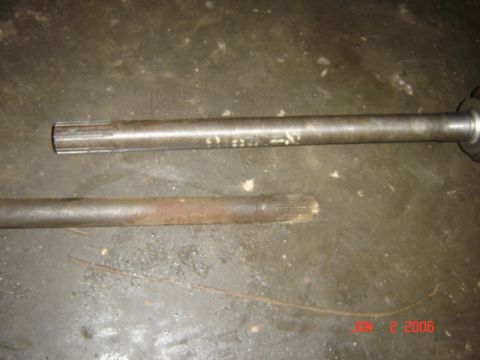 1982 Nissan Titan - Two drive shafts are shown on a concrete floor. One appears to be in better condition than the other.