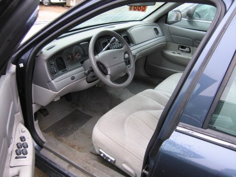 1991 Ford Crown Victoria LTD - Interior view of a 1991 Ford Crown Victoria LTD, showing the dashboard, seats, and door panel.