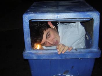 1994 Ford Taurus - A person is humorously stuck inside a blue trash can.