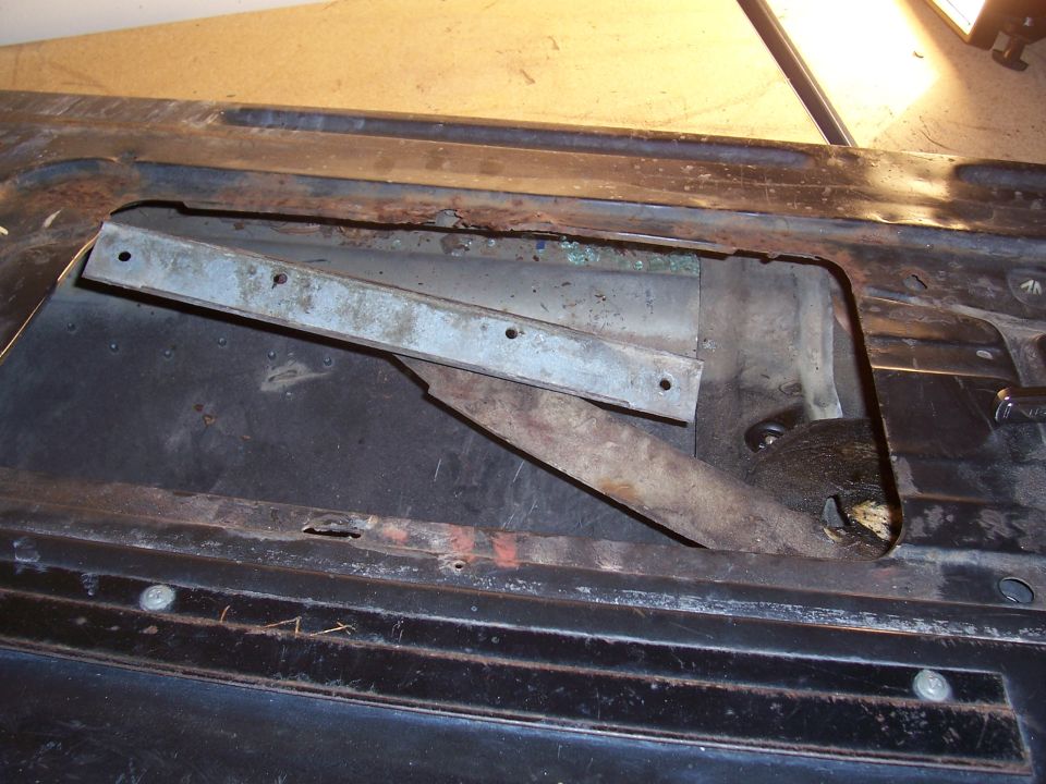 This is the window holder with the window removed. Removal is easy. Just undo four nuts and lift off.  Remove the old grease and use new grease on these. You'll notice a big difference in how smooth your window works afterwards.