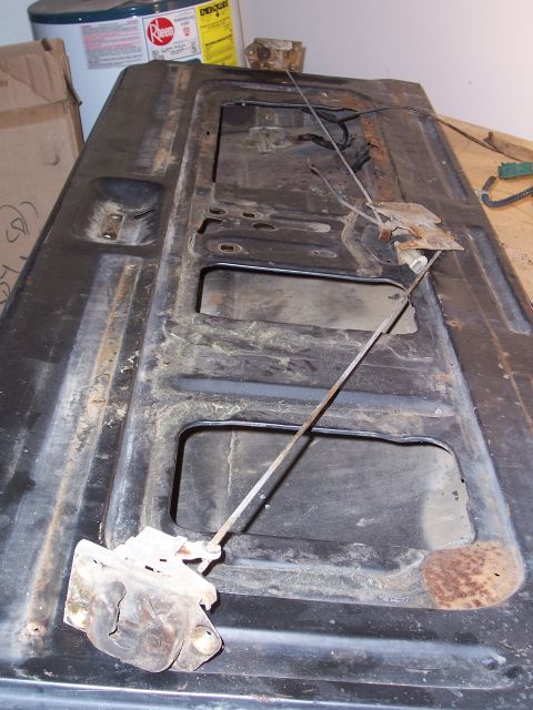 1978 Ford Bronco - Close-up of a vehicle's tailgate latch mechanism, showing internal components and signs of wear.