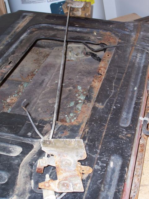 1978 Ford Bronco - The internal mechanism of a vehicle's tailgate latch shows significant rust and wear.