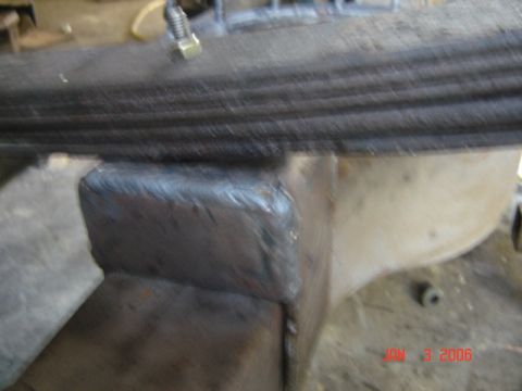 1982 Nissan Titan - A close-up view shows a freshly welded mount for a leaf spring suspension component.