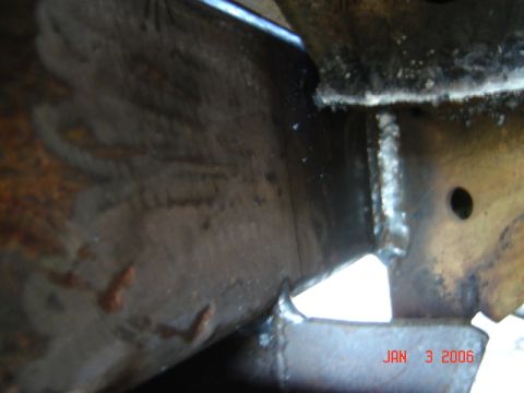 1982 Nissan Titan - Close-up view of welded metal components, showing rust and a date stamp.