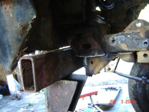 1982 Nissan Titan - Close-up view of heavily rusted frame and suspension components, with visible text overlay from the original source.