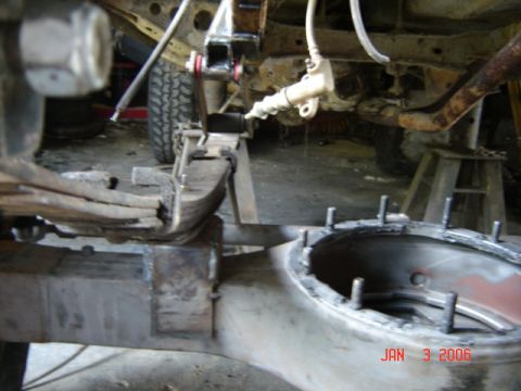1982 Nissan Titan - Close-up view of a truck's suspension and rear axle components during repair work.