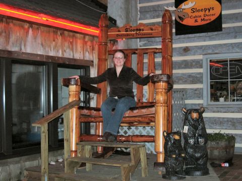 1985 Ford LTD Crown Victoria - A woman poses in a giant wooden rocking chair outside a shop in Gatlinburg, Tennessee.