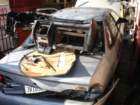 1993 Ford Taurus - The interior of a 1993 Ford Taurus is exposed with the dashboard removed, showing disassembled components.