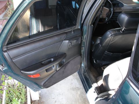 1993 Ford Taurus - Interior view of a 1993 Ford Taurus, highlighting the black leather seats and door panel details.