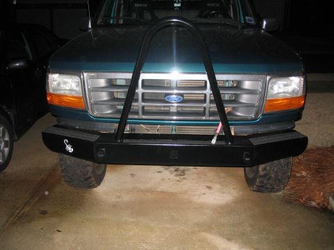 1996 Ford Bronco - Front view of a green 1996 Ford Bronco a custom bumper and brush guard.