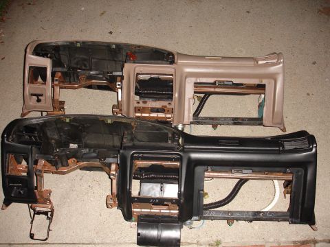1993 Ford Taurus - Disassembled car dashboards, one tan and one black, are shown side-by-side.