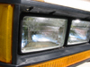1997 Ford Crown Victoria - Headlight and turn signal assembly from a vehicle, showing the glass lens and plastic housing.