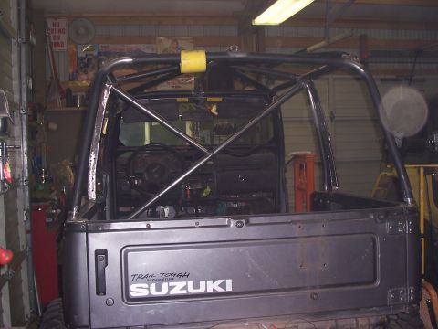 1988 Suzuki Samurai - The rear of a Suzuki Samurai is shown with a custom roll cage installed inside the cabin.