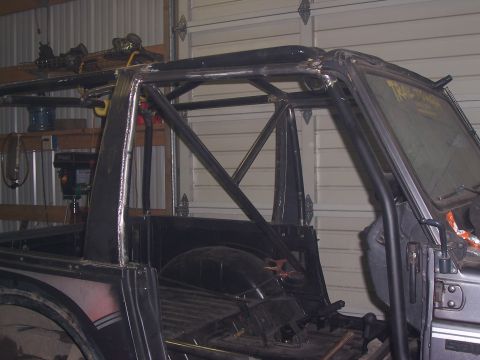 1988 Suzuki Samurai - This vehicle features a custom roll cage, obscuring original body details and making year identification difficult.