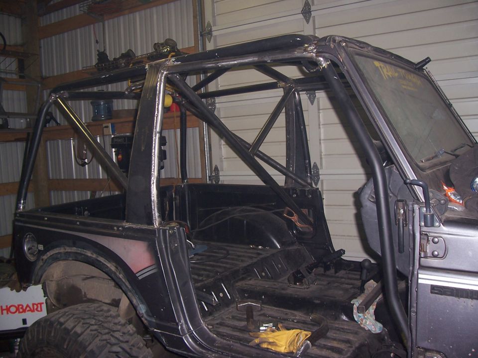 Suzuki Samurai with custom roll cage installed, interior stripped down