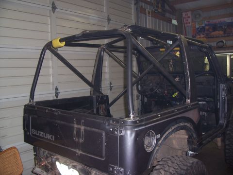 1988 Suzuki Samurai - This 1988 Suzuki Samurai is equipped with an aftermarket roll cage, indicating modifications for off-road use.