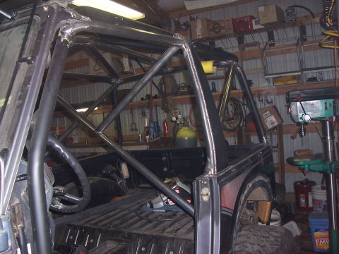 1988 Suzuki Samurai - A custom roll cage is installed inside a vehicle, obscuring much of the interior details.