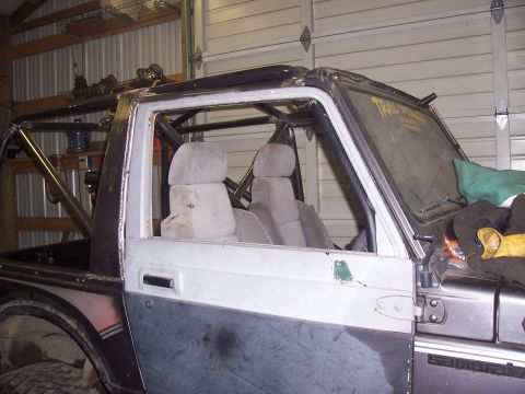 1988 Suzuki Samurai - This Suzuki Samurai has a custom roll cage and appears to be undergoing modifications.