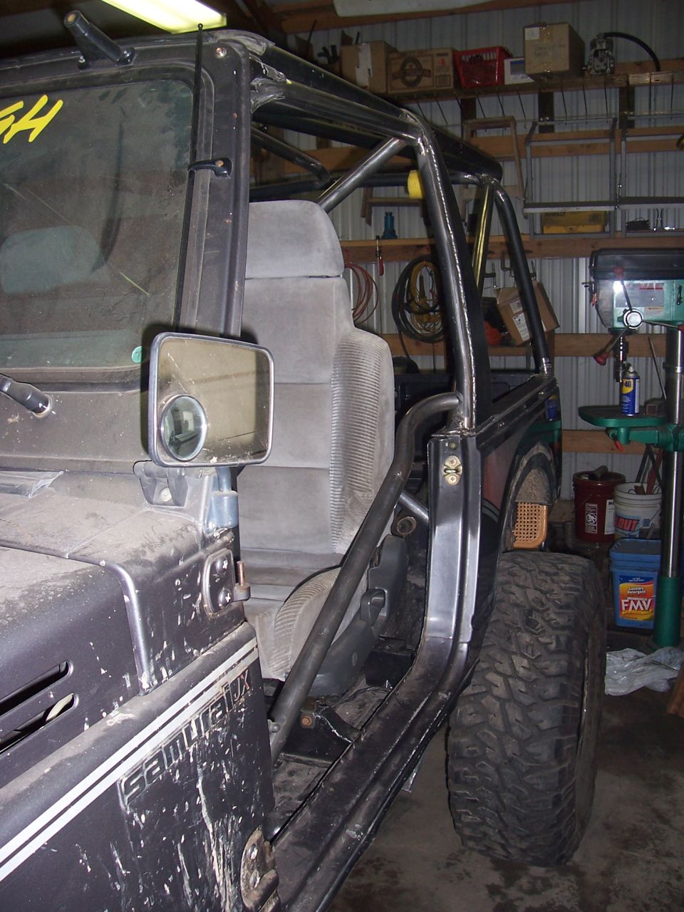 Suzuki Samurai side view with roll cage and large tires