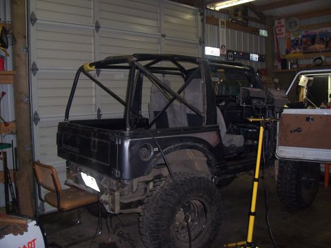 1988 Suzuki Samurai - This Suzuki Samurai features a custom roll cage and appears to be undergoing modifications.