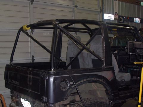 1988 Suzuki Samurai - This Suzuki Samurai has been modified with a substantial roll cage, covering the interior and extending to the rear.