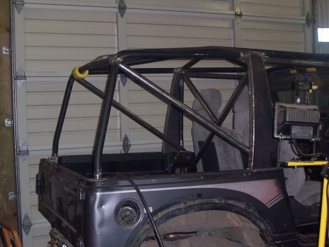1988 Suzuki Samurai - A 1988 Suzuki Samurai is shown with a custom roll cage installed in the rear.