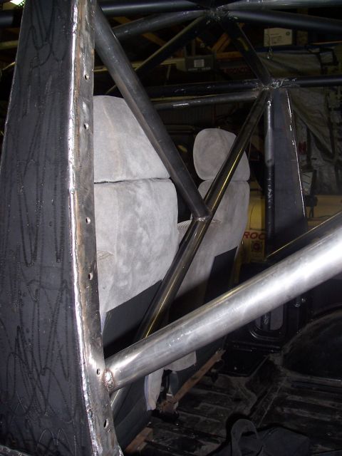 1988 Suzuki Samurai - Custom roll cage structure is welded inside a vehicle, obscuring most of the interior.