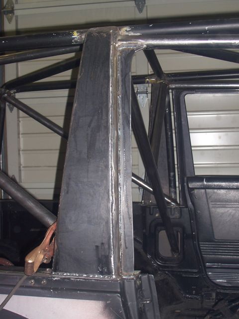 1988 Suzuki Samurai - Close-up view of a custom-welded roll cage inside a vehicle's interior.