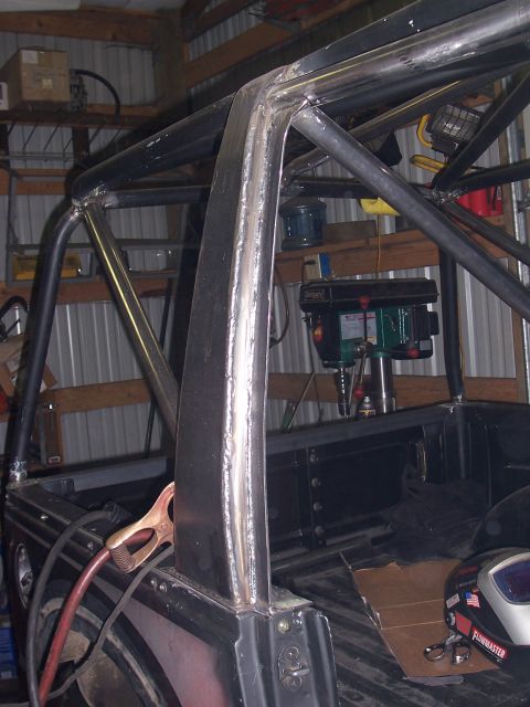 1988 Suzuki Samurai - Custom roll cage fabrication in progress inside a vehicle. Drill press visible in background.