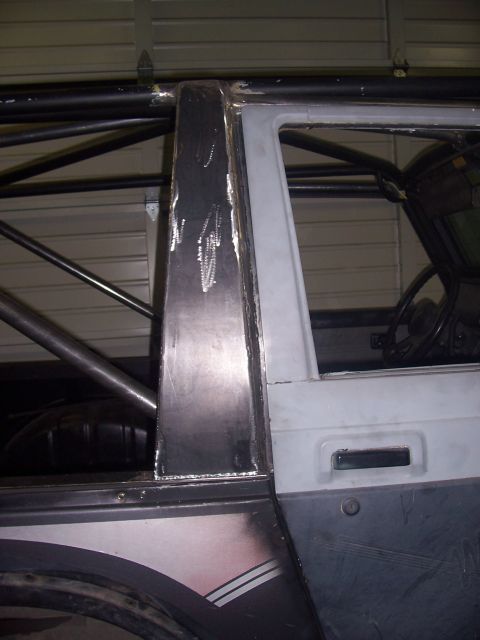1988 Suzuki Samurai - Custom roll cage and metalwork are visible inside a vehicle, obscuring its specific make and model year.