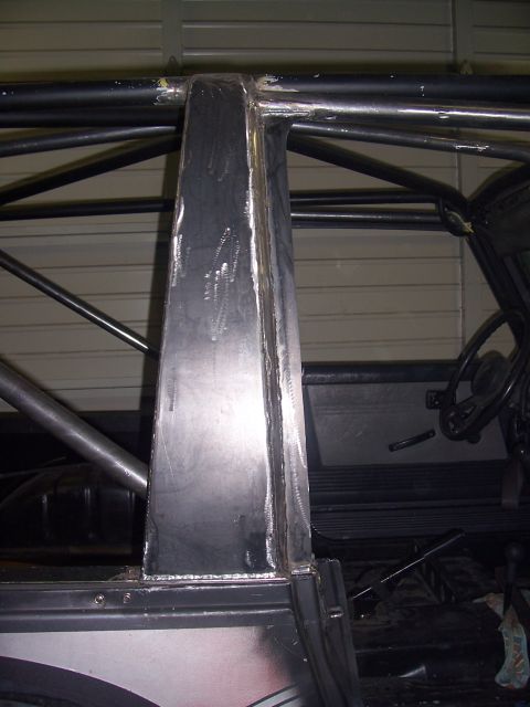 1988 Suzuki Samurai - Custom roll cage structure inside a vehicle, with a steering wheel and door handle visible.